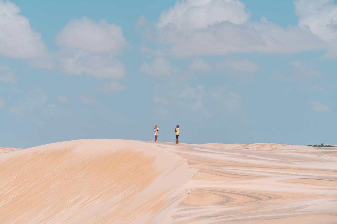A couple standing on a sand dune in Atins