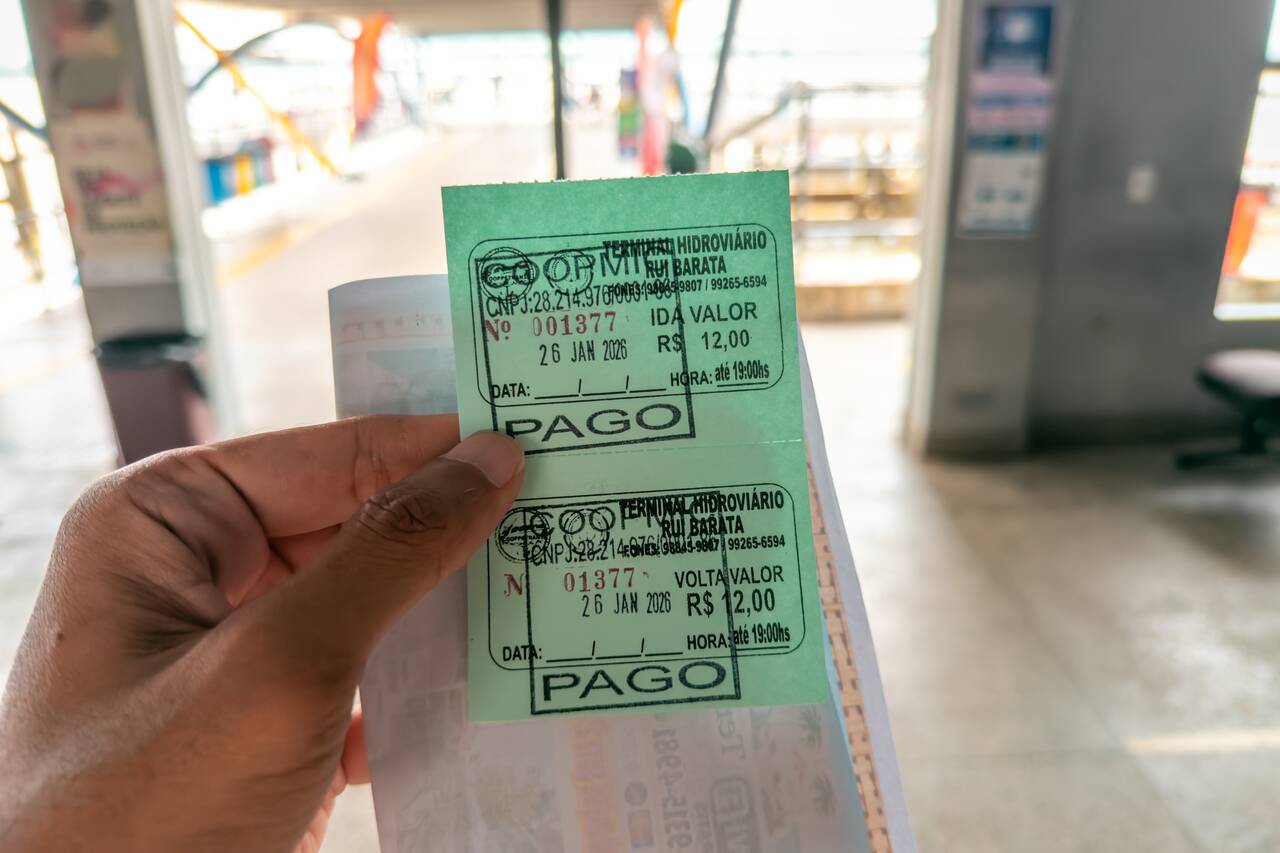 Me holding a boat ticket to Ilha do Combu