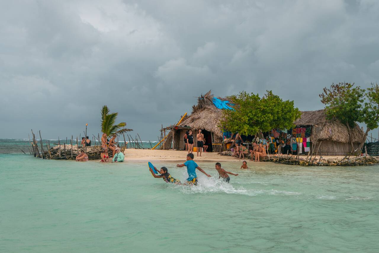 Kids running in the water at Isla Mynor at San Blas Islands