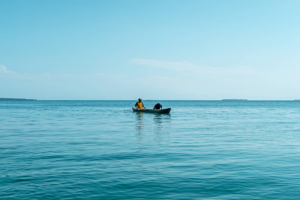 A local rolling a boat on a calm morning in Bocas del Toro