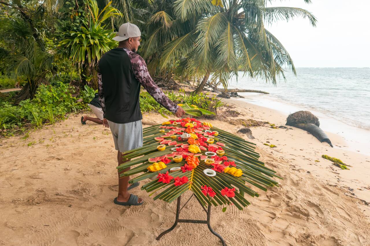 A guide preparing fruits for us at Zapatilla Island