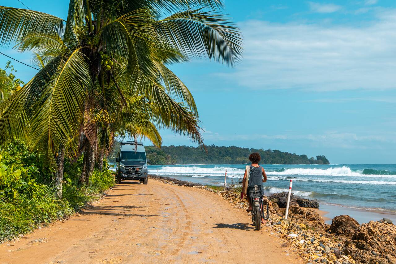 A person biking along the beach on Isla Colon