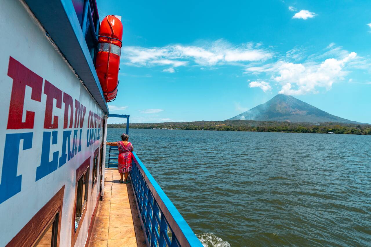 A woman looking at Concepcion Volcano from the ferry