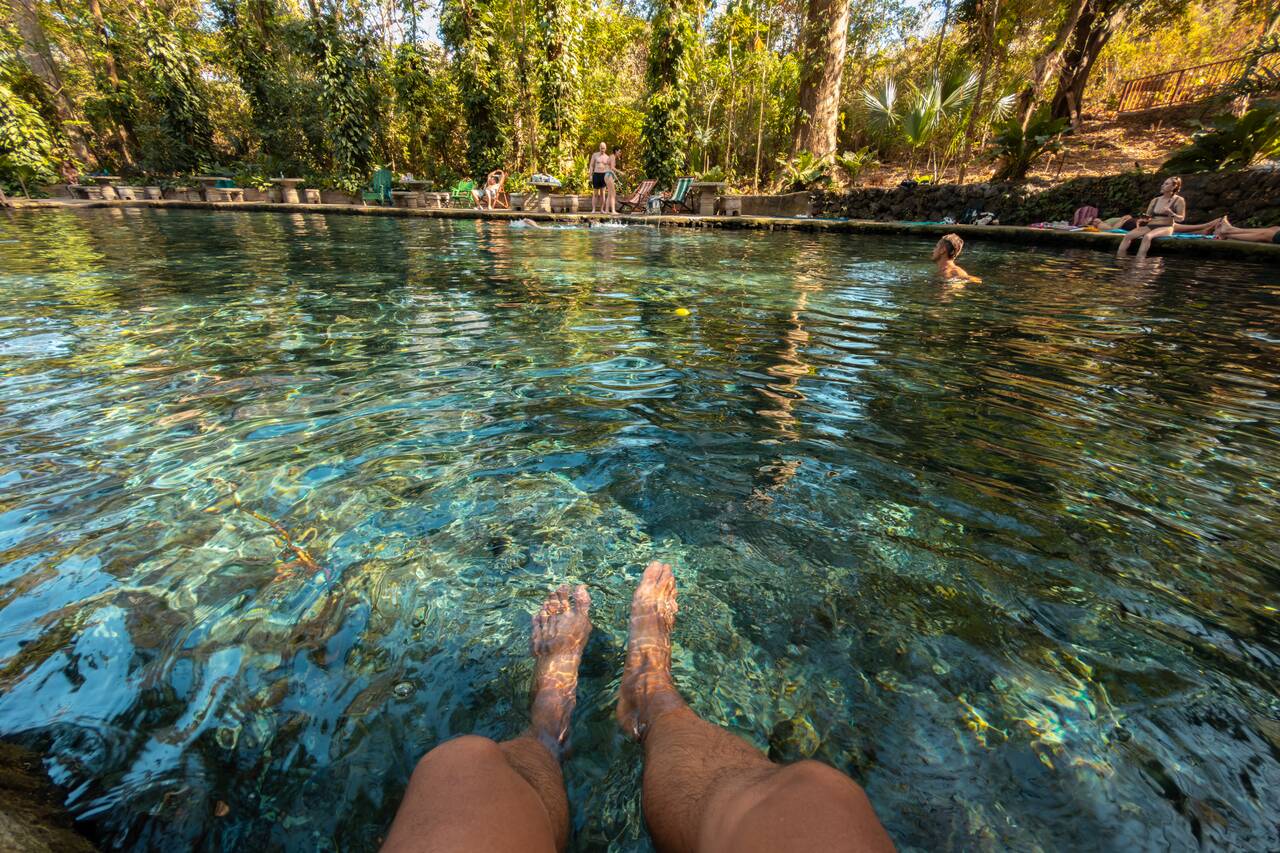 My legs in the crystal clear water of Ojo de Agua