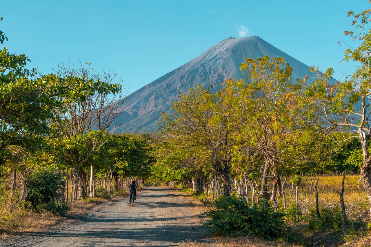 A kid on a bike along the dirt road in Ometepe