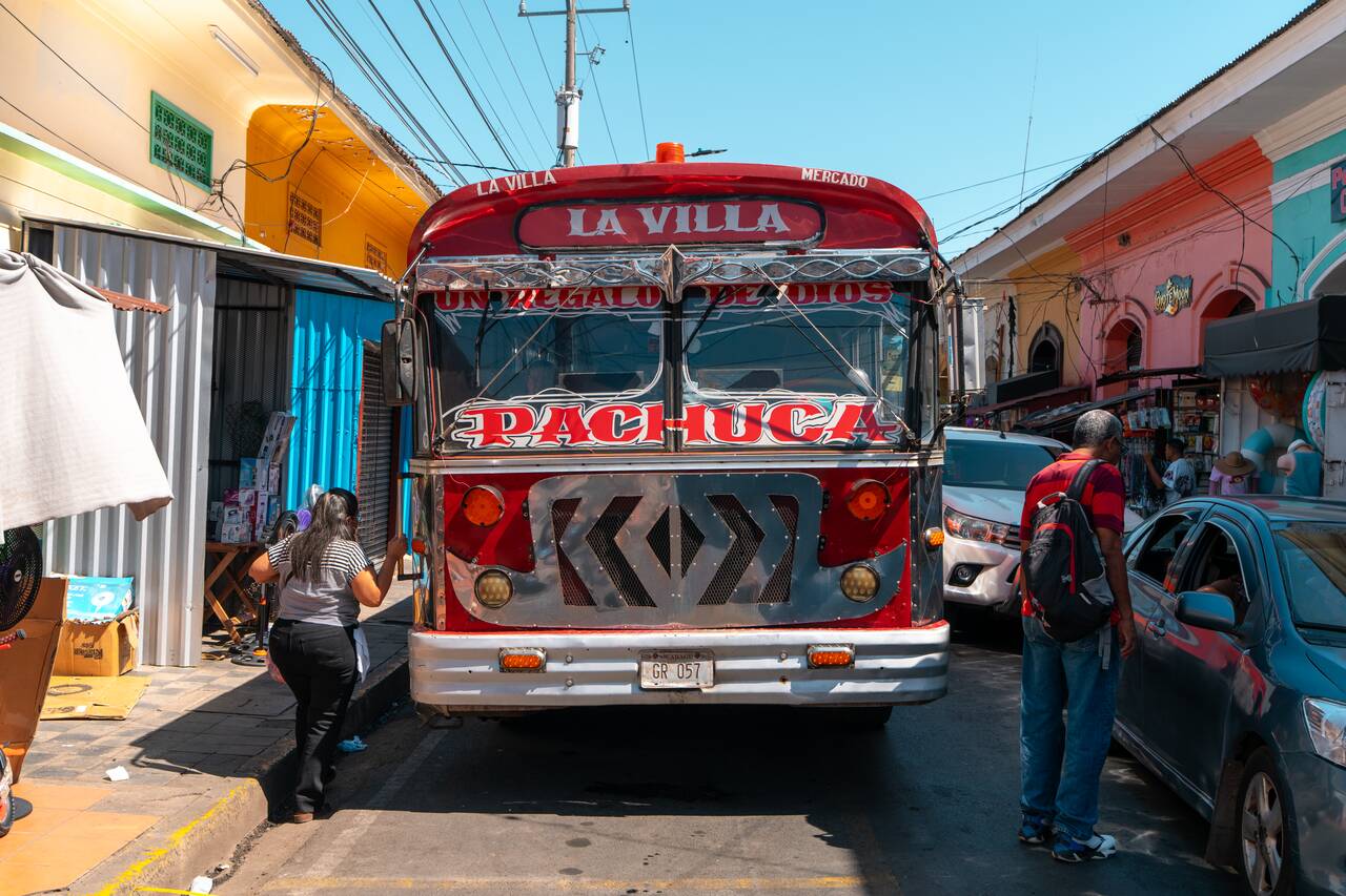 People going up a Chicken Bus in Granada