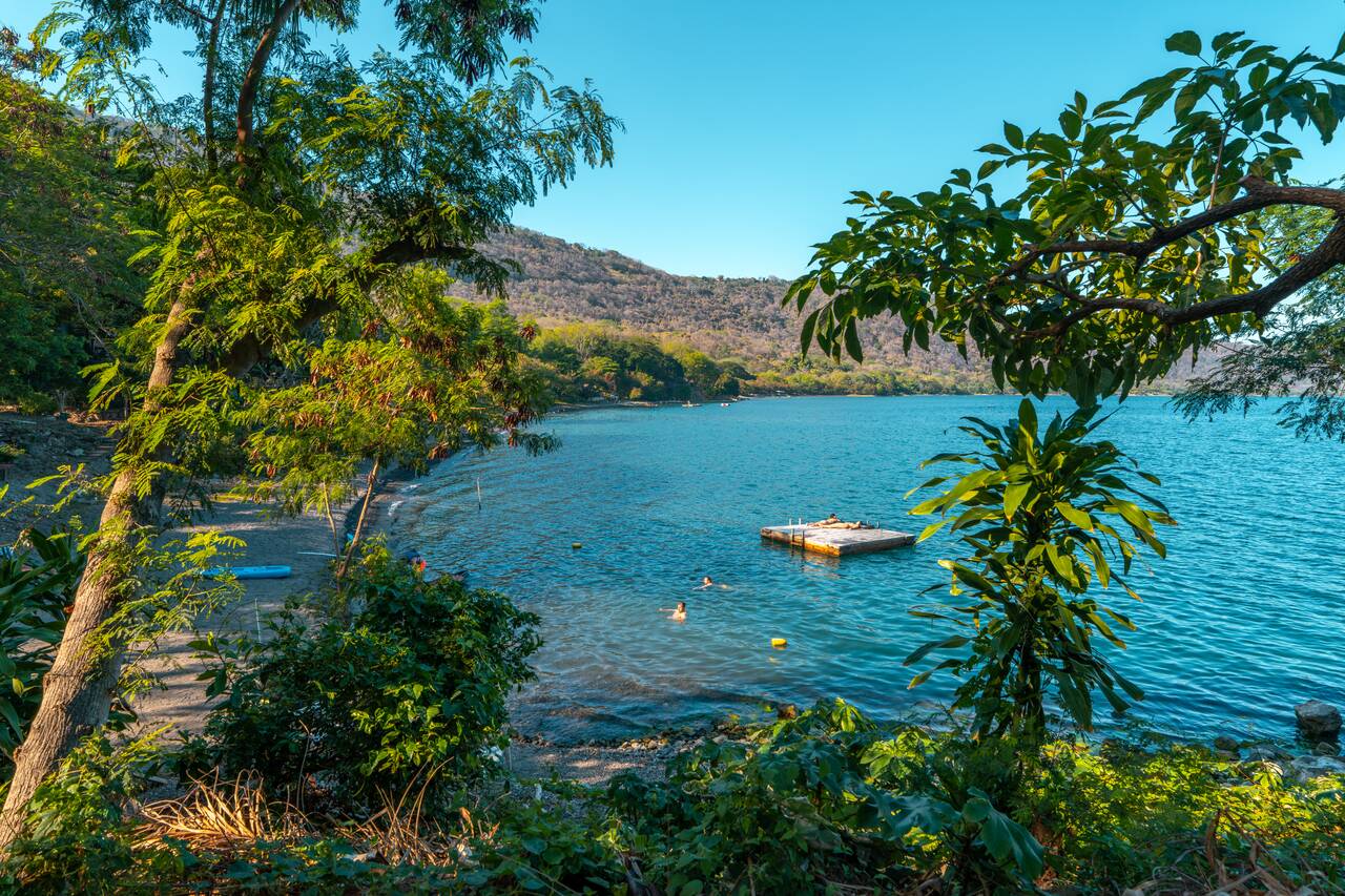 People swimming in the lake in the evening at Coco Bay Hostel