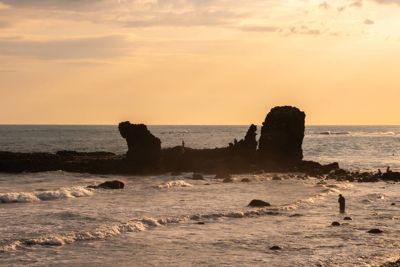 A rock formation at El Tunco Beach at sunset