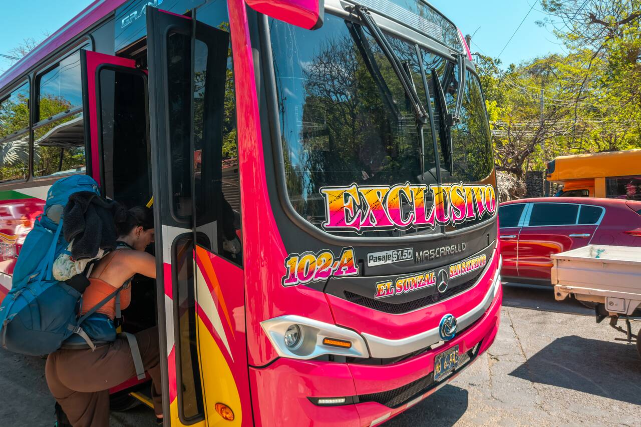 A backpacker going up 102A bus in El Tunco