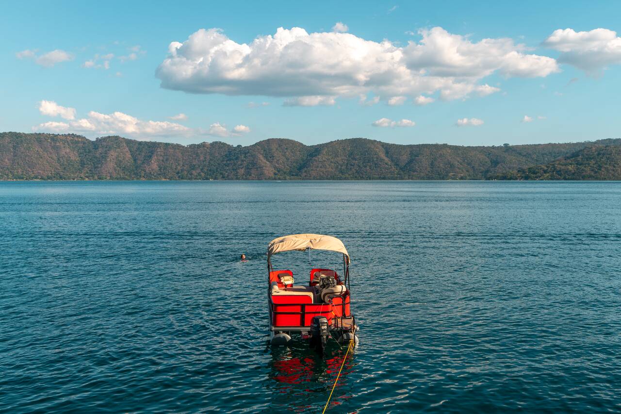 A boat floating in Lake Coatepeque