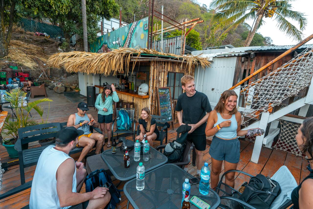 My friends sitting at the restaurant at Captain Morgan Hostel at Lake Coatepeque