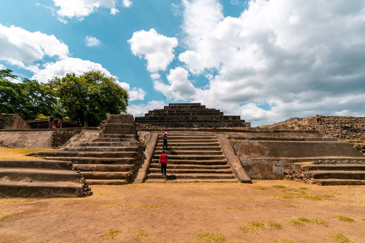 People climbing up stairs at Tazumal