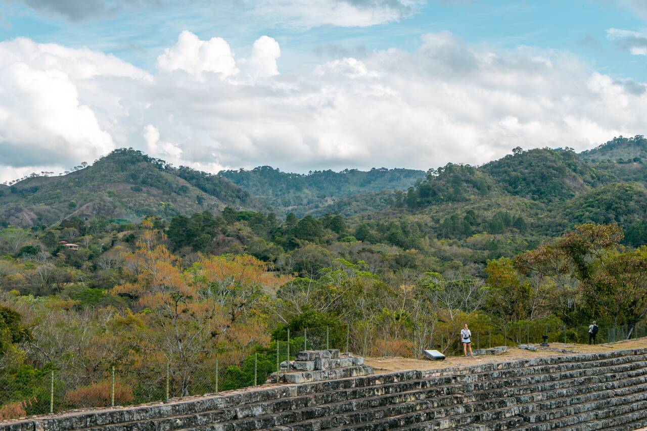 My friend standing on the wall overlooking the view around Copan