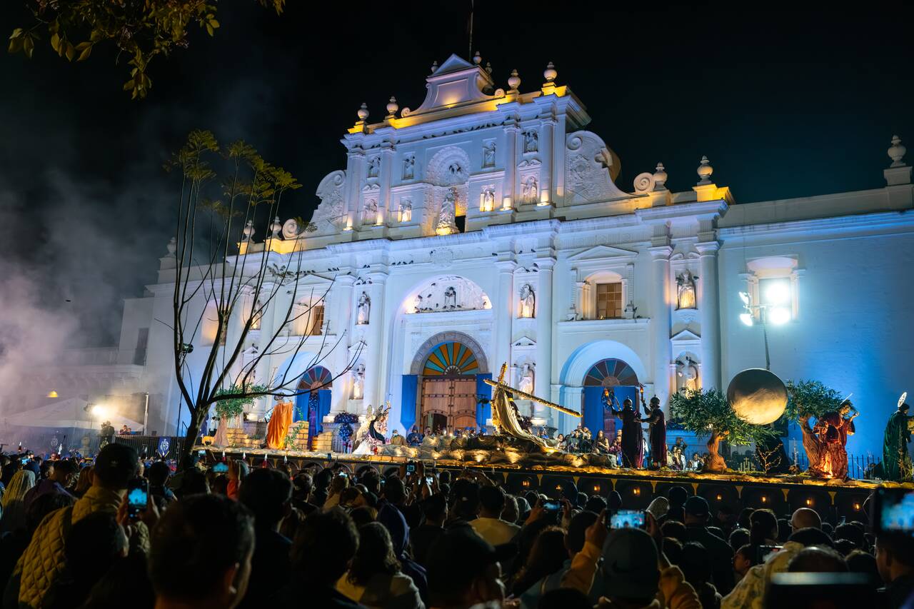 A christ carrying a cross procession at Parque Central at night during Semana Santa