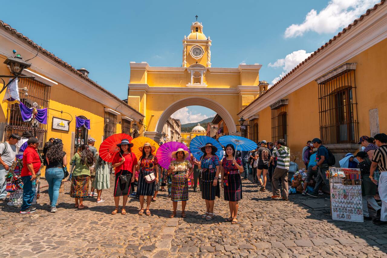 Local ladies wearing traditional dresses taking photos at Santa Catalina Arch