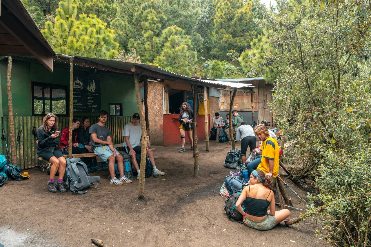 People resting at rest stops along Acatenango Hike