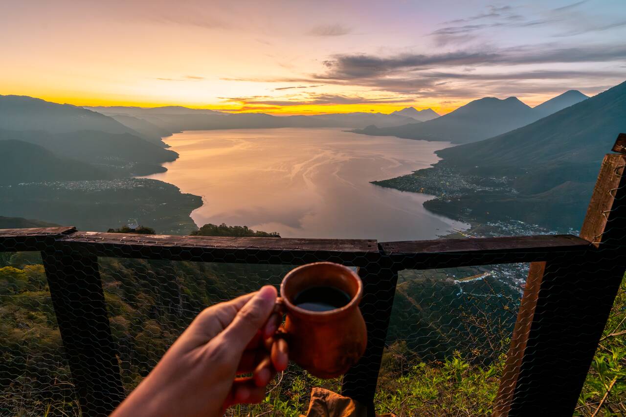 Me holding the free coffee while enjoying the view at the Indian Nose Viewpoint