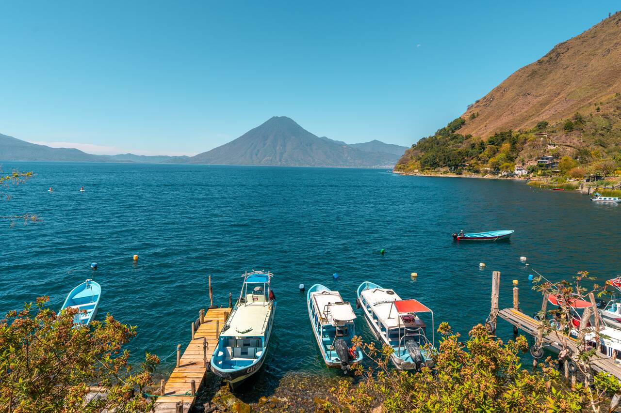 Boats parked along the coastline of Lake Atitlan