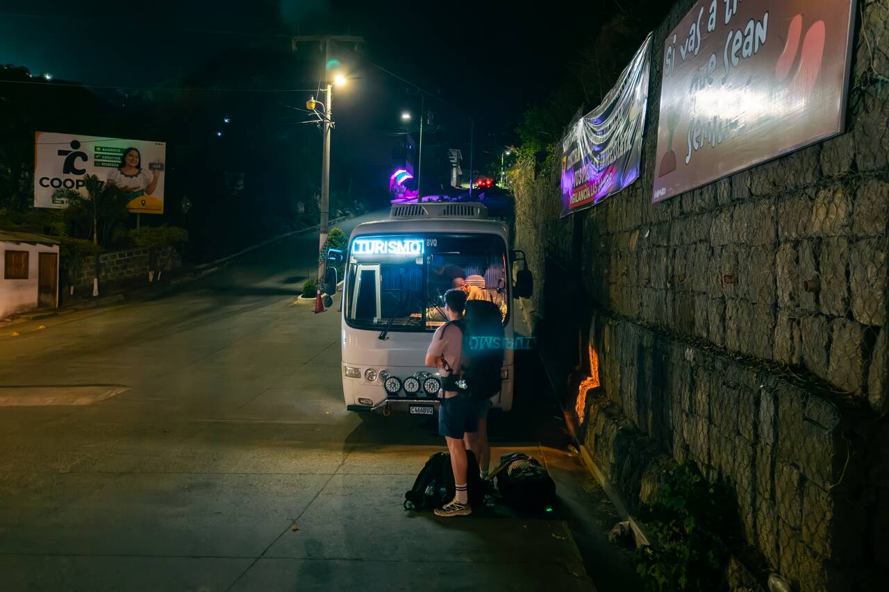 Backpackers waiting at the intersection where the overnight bus from lake atitlan to Semuc Champey leaves in San Pedro la Laguna