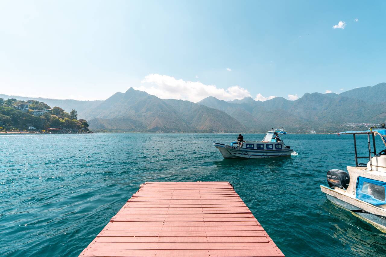 a speed boat at Lake Atitlan arriving at a pier