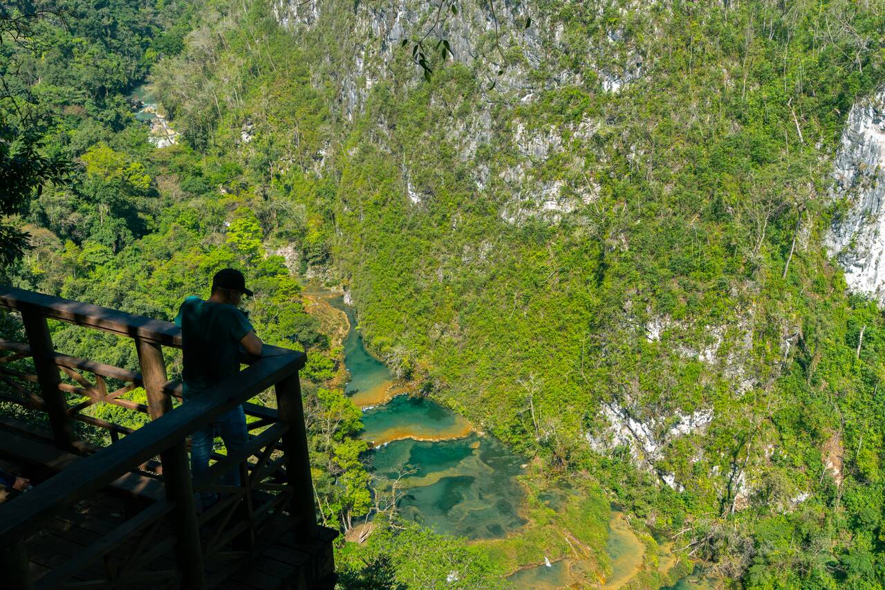 A person looking at the view of Semuc Champey from the viewpoint