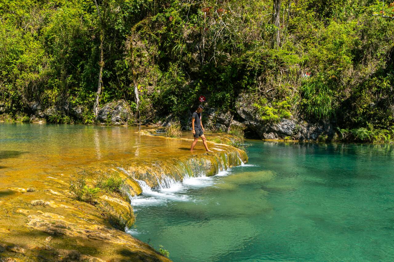 Me walking along the cascade of the Turquoise Limestone Pools in Semuc Champey