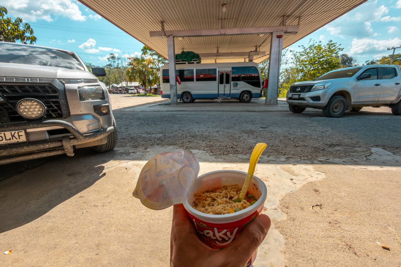 Me eating instant noodle while I wait for the bus to Flores