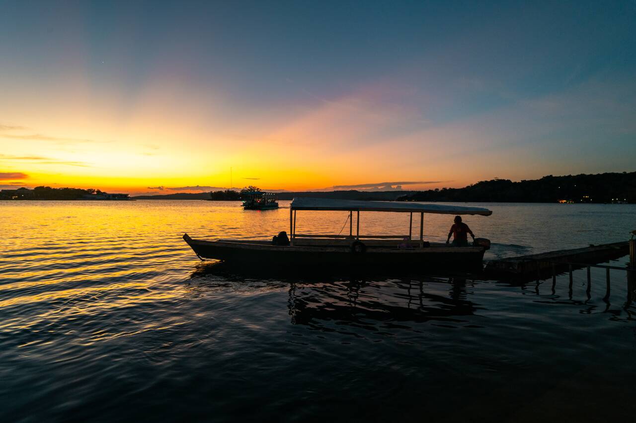 A boat leaving flores at sunset