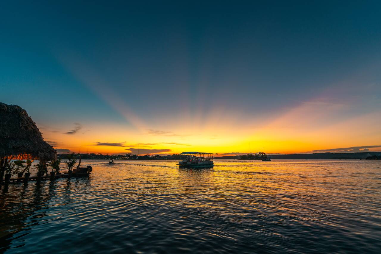 A boat coming and going seen from Malecon at sunset