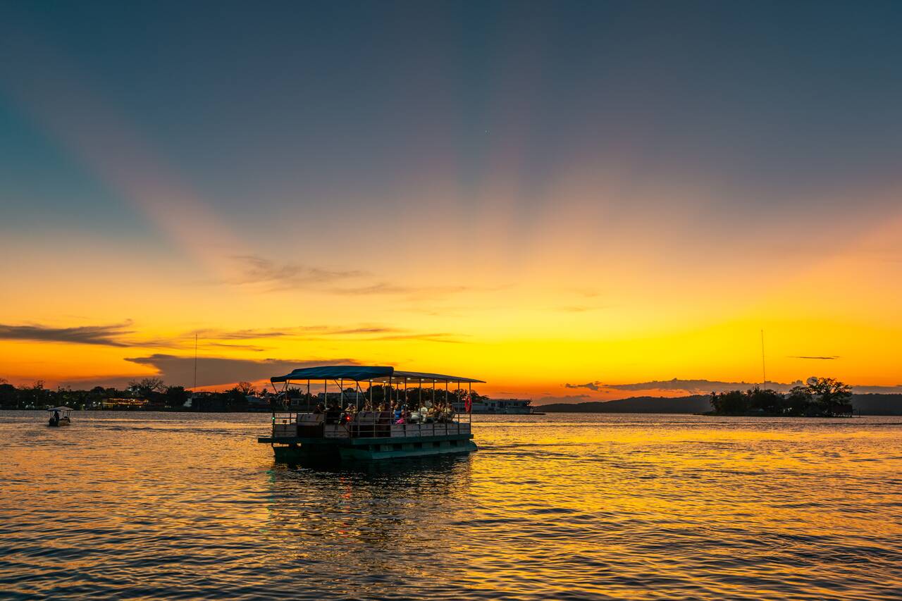 A boat crossing the lake in Flores at sunset