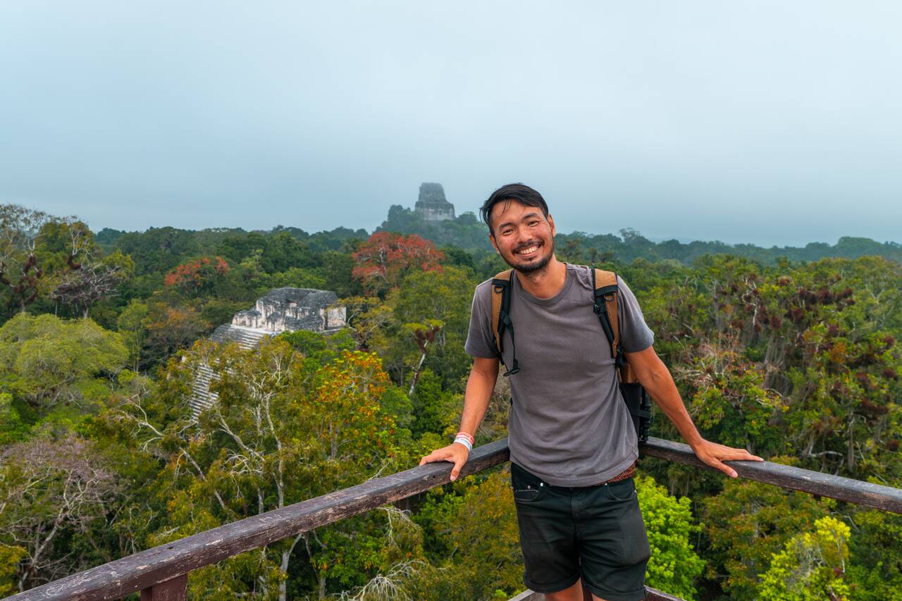 Me smiling at a cloudy view in Tikal