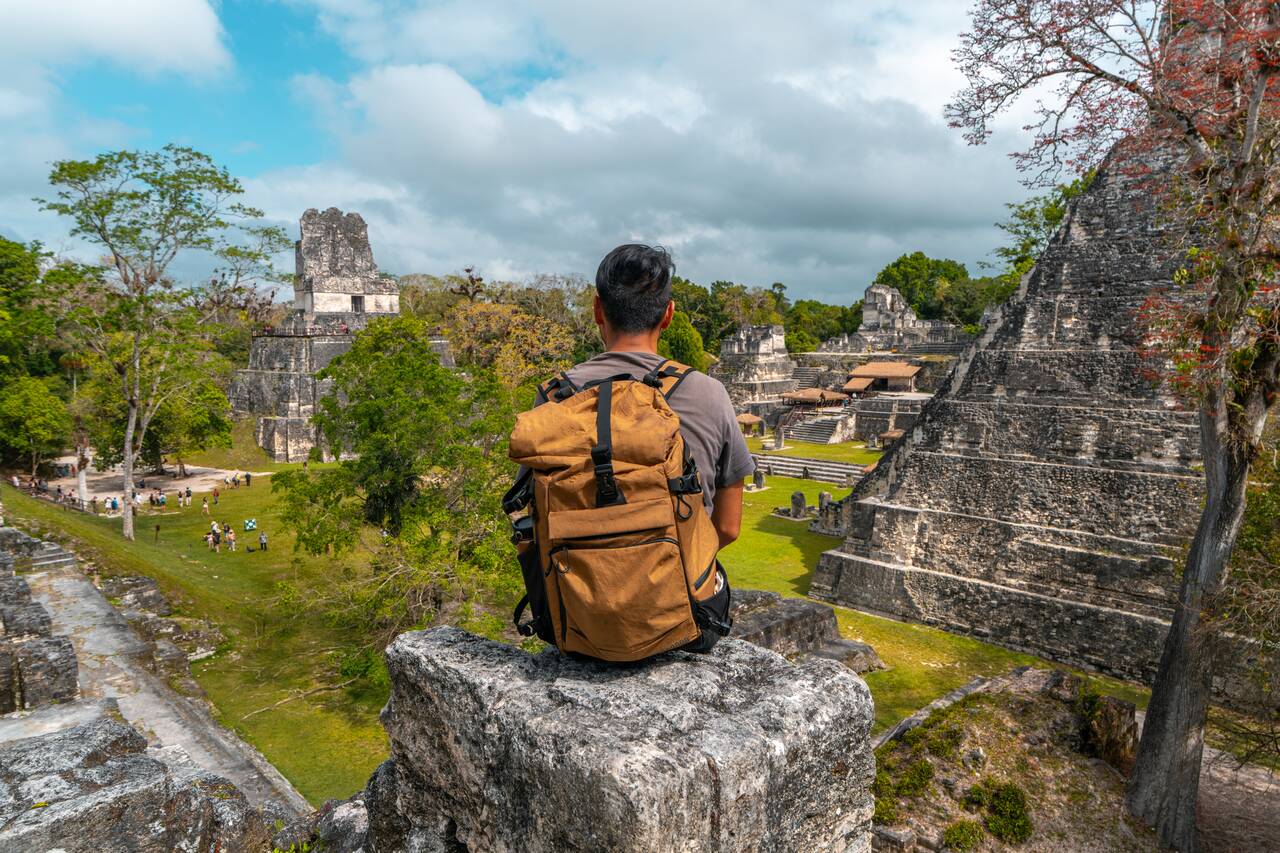 Me sitting looking at Tikal Grand Plaza