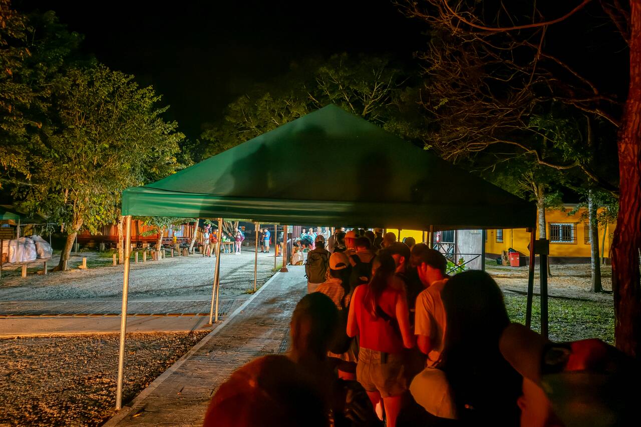 People queuing to enter Tikal at sunrise