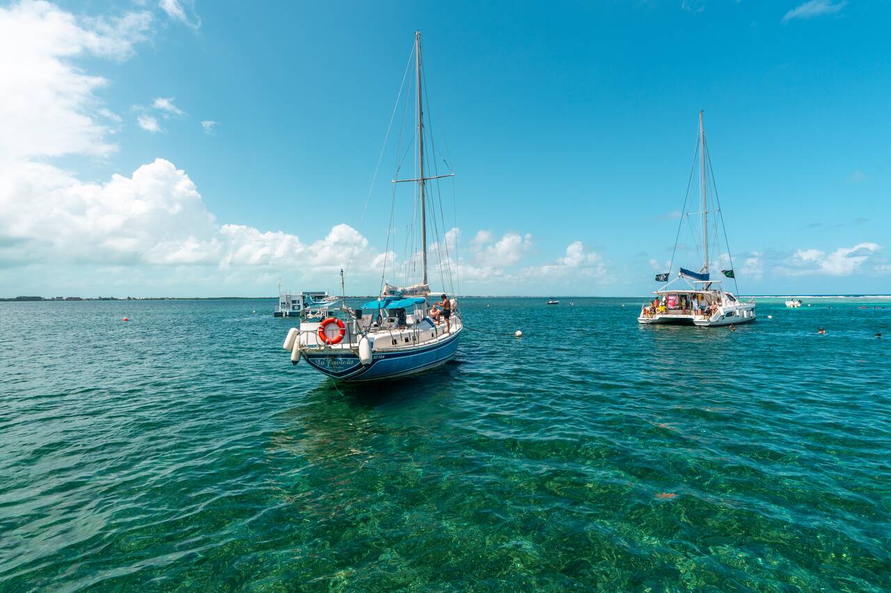 A boat floating on the Crystal clear water at Hol Chan Marine Reserve