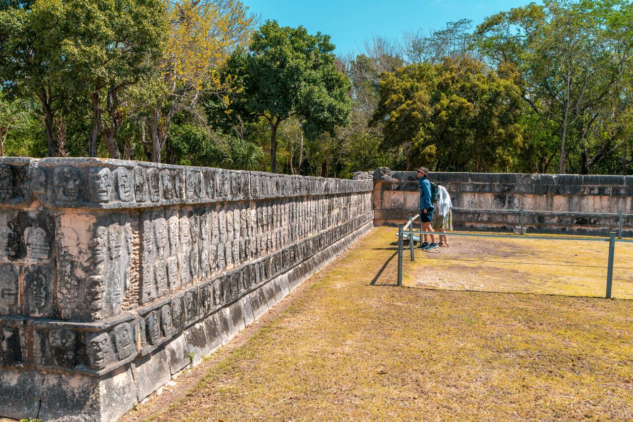 Skulls sculpted into a wall of an altar in Chichen Itza