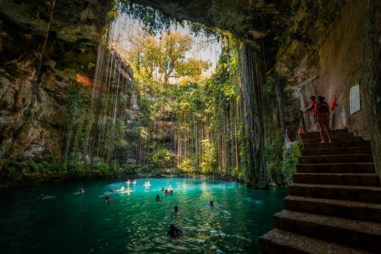 People getting ready to jump at Ik Kil Cenote