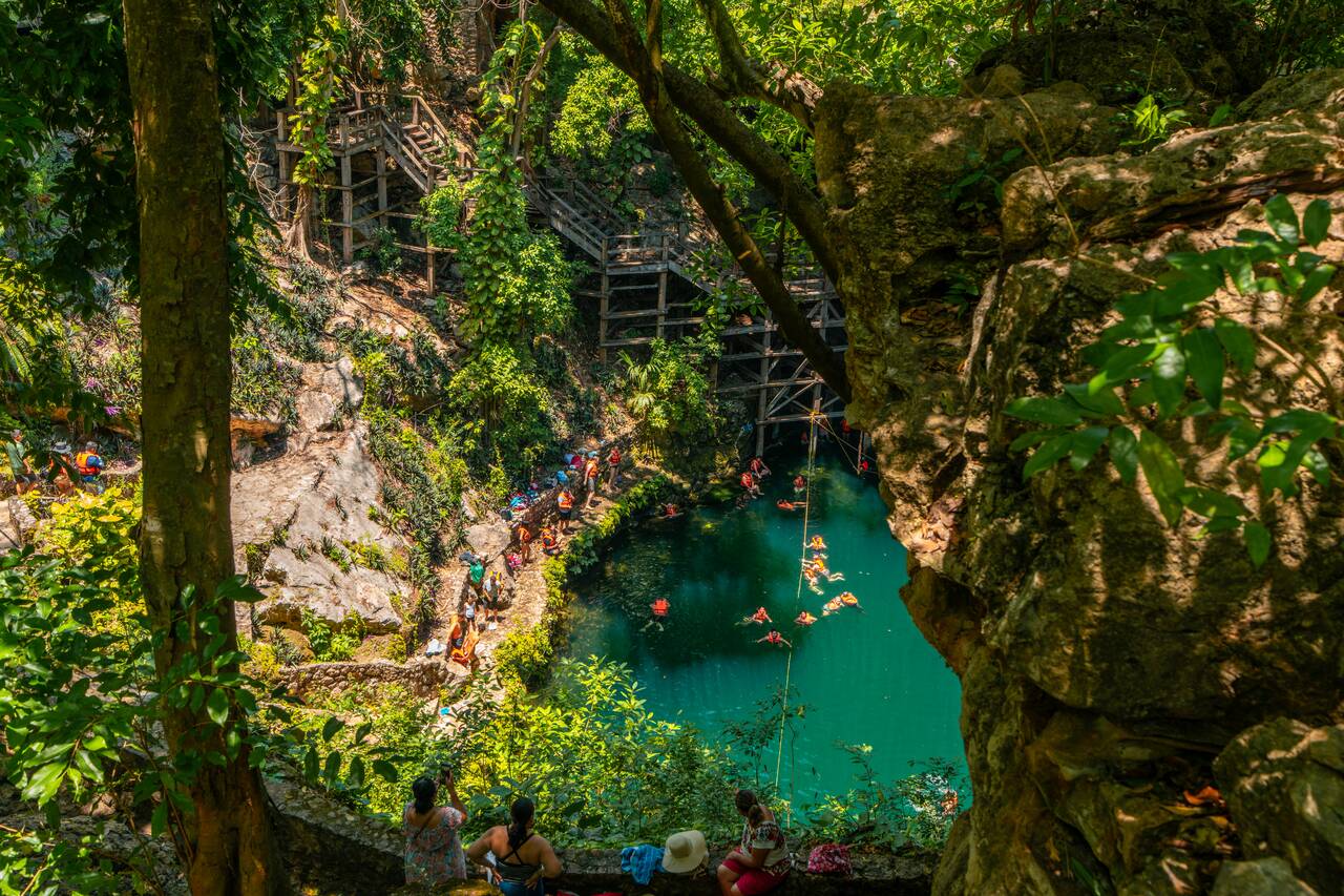 Lots of people swimming at Cenote Zací