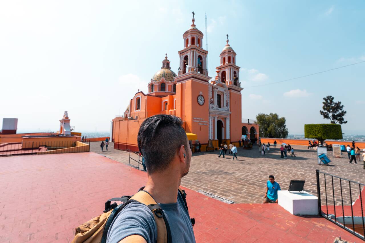 Me looking at the basilica on top of a pyramid in Cholula