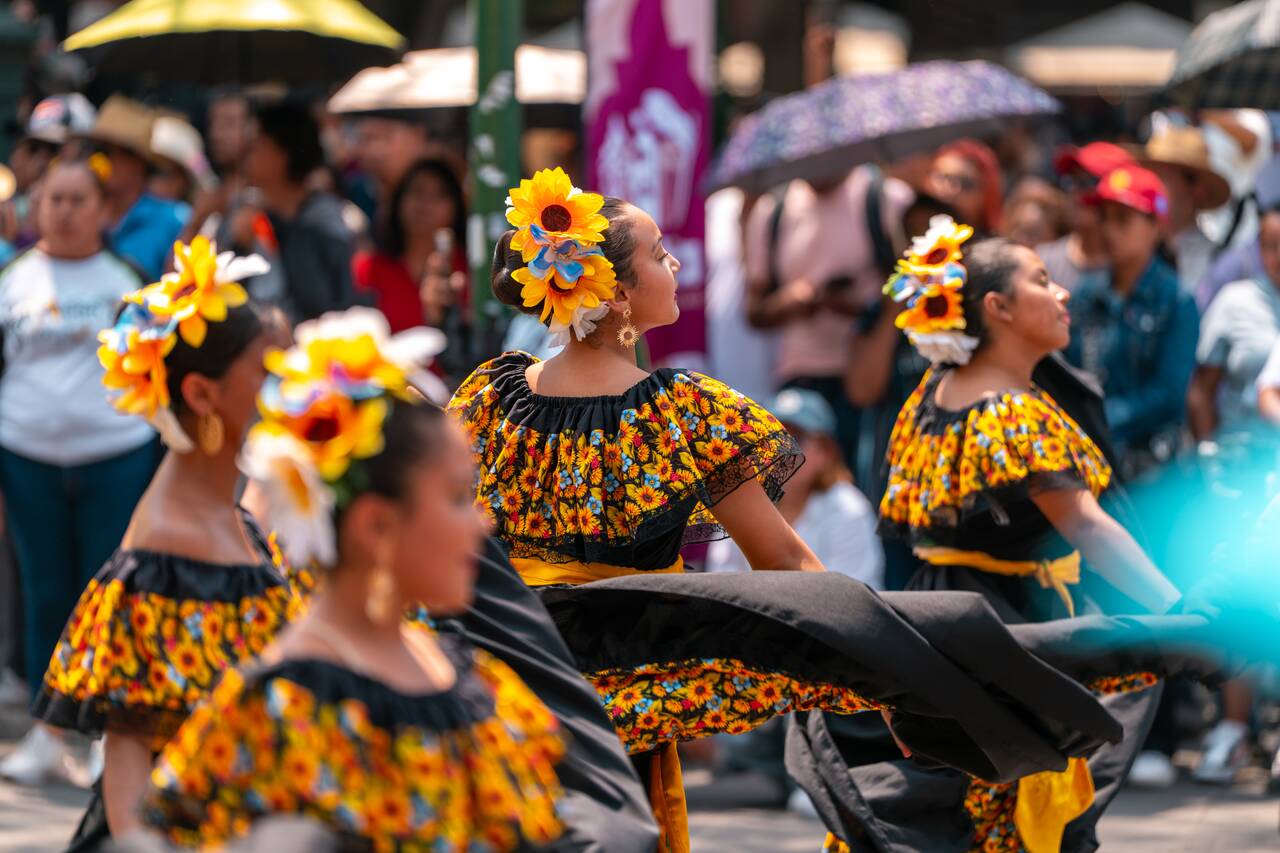 Students in traditional attire performing at Puebla's Historic Center
