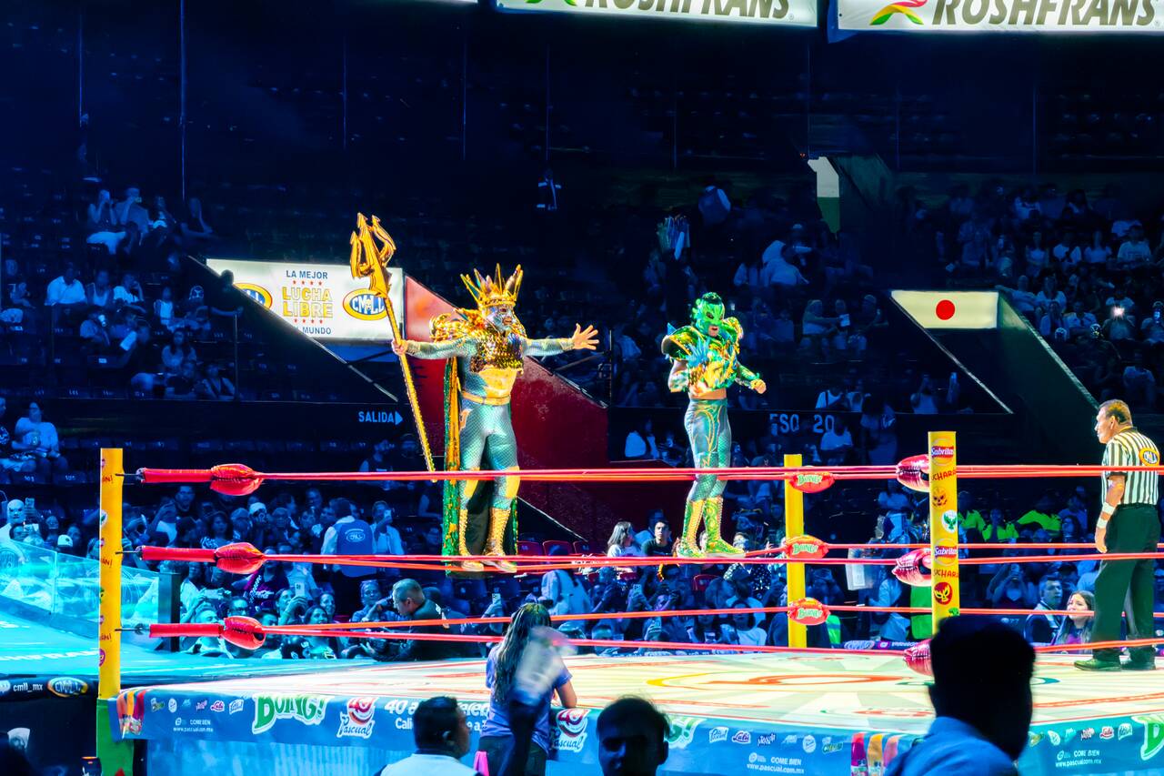 Wrestlers in costumes at Lucha Libre show