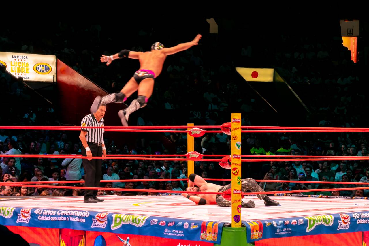 A wrestler flying off the rope at Lucha Libre show