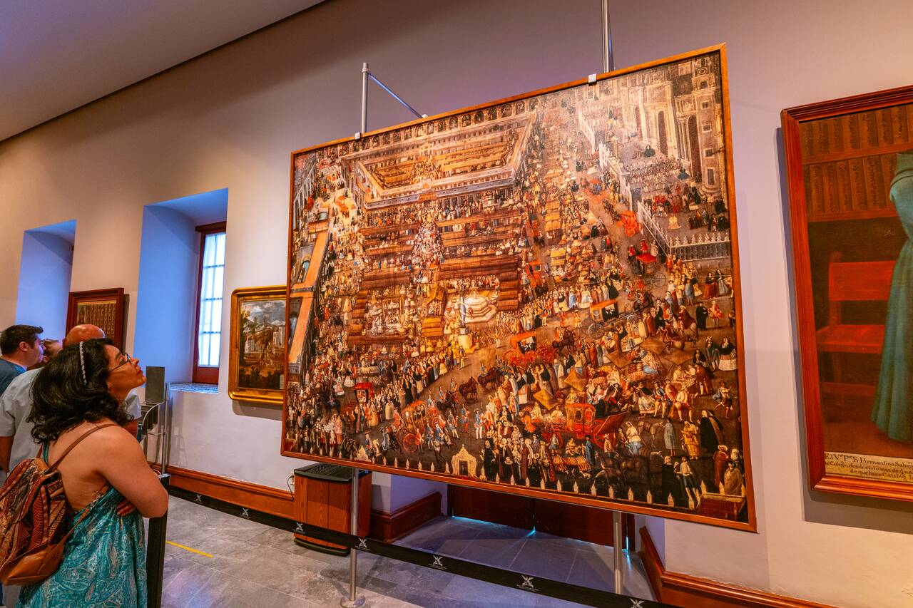 A woman looking at a painting inside Chapultepec Castle