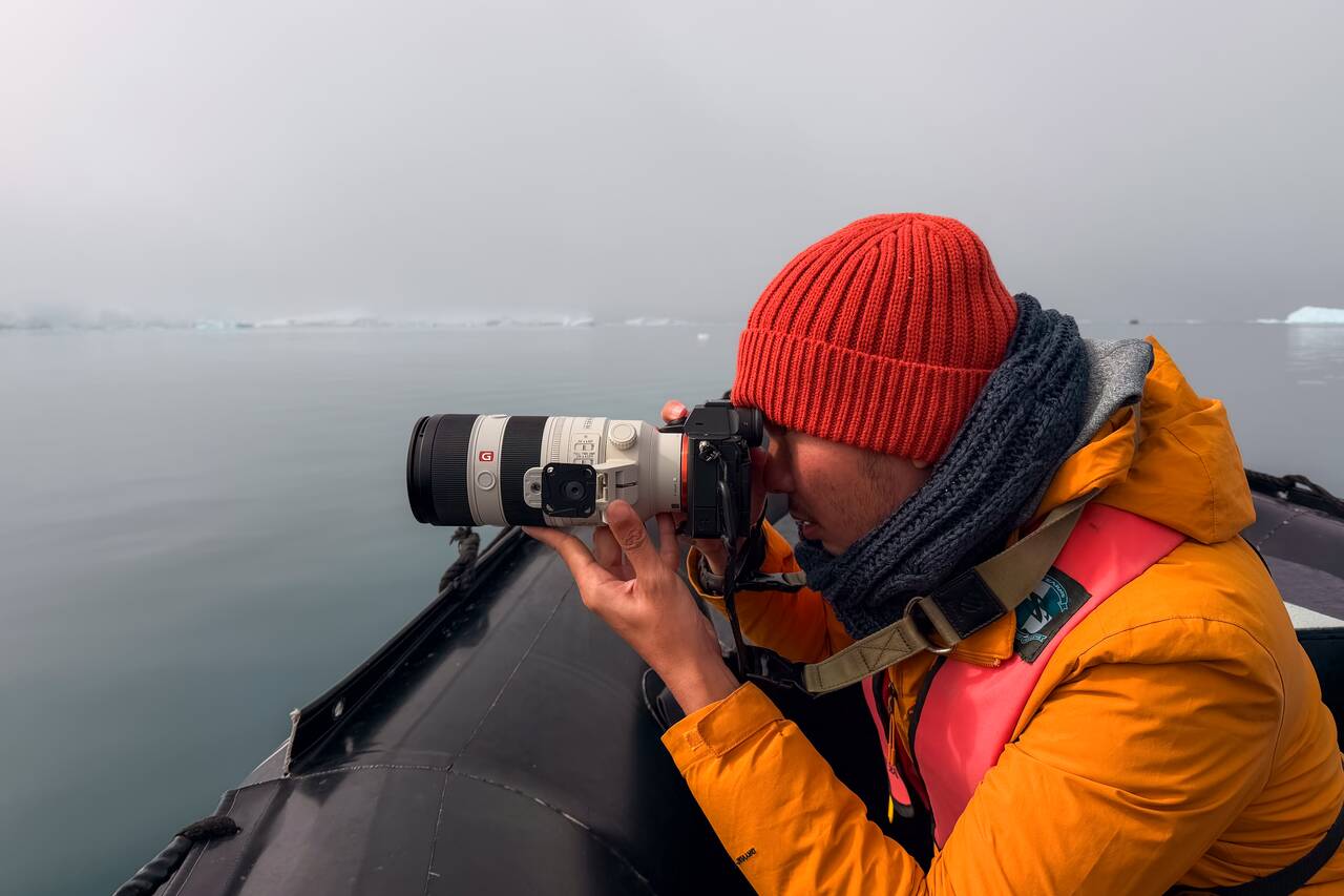 Me holding a telephoto lens in Antarctica