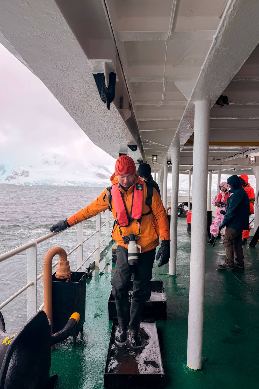 Me cleaning my boots before boarding a ship in Antarctica