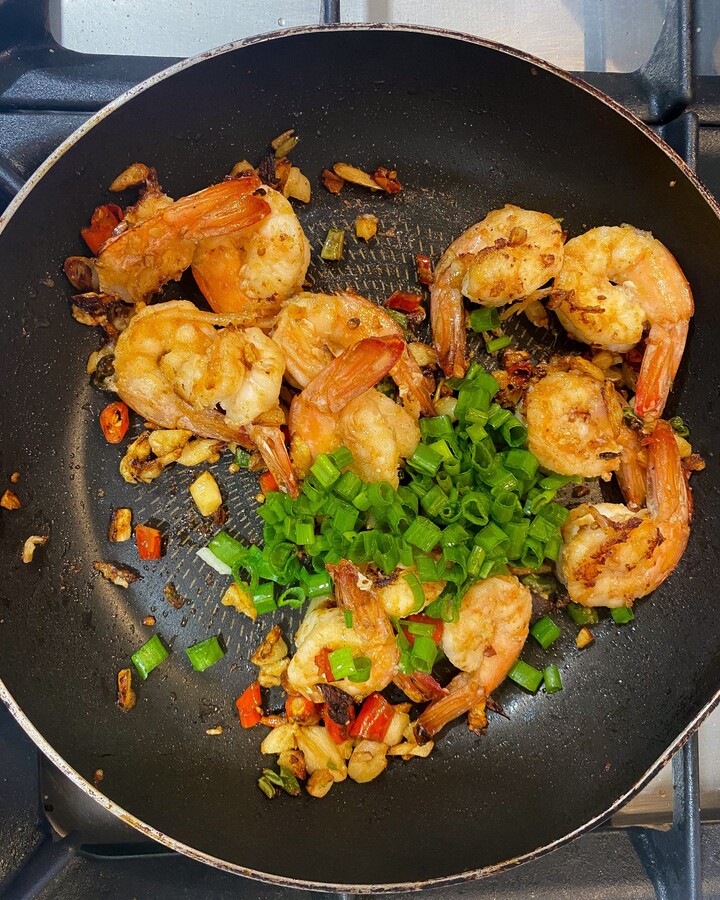 Add spring onion, mix it and remove the heat. Don’t take time too long for this step. Because the shrimp will be overcooked and not juicy.