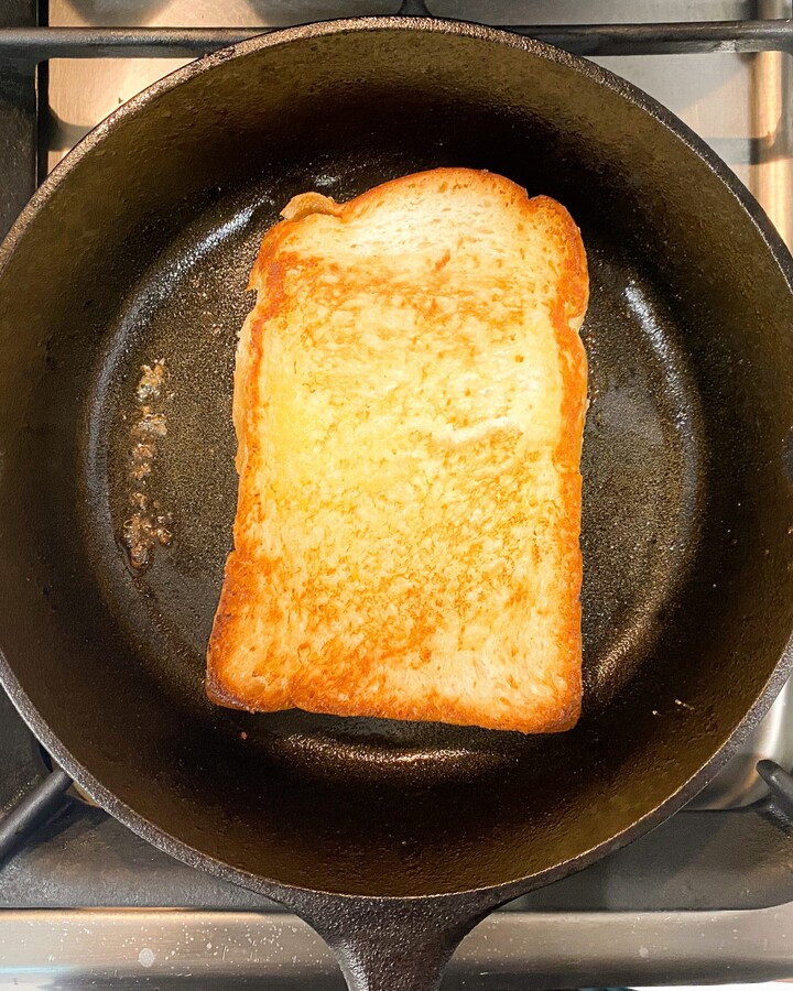 Spread butter on bread slices and place the buttered bread on a skillet pan and cook until it is brown and crispy golden.