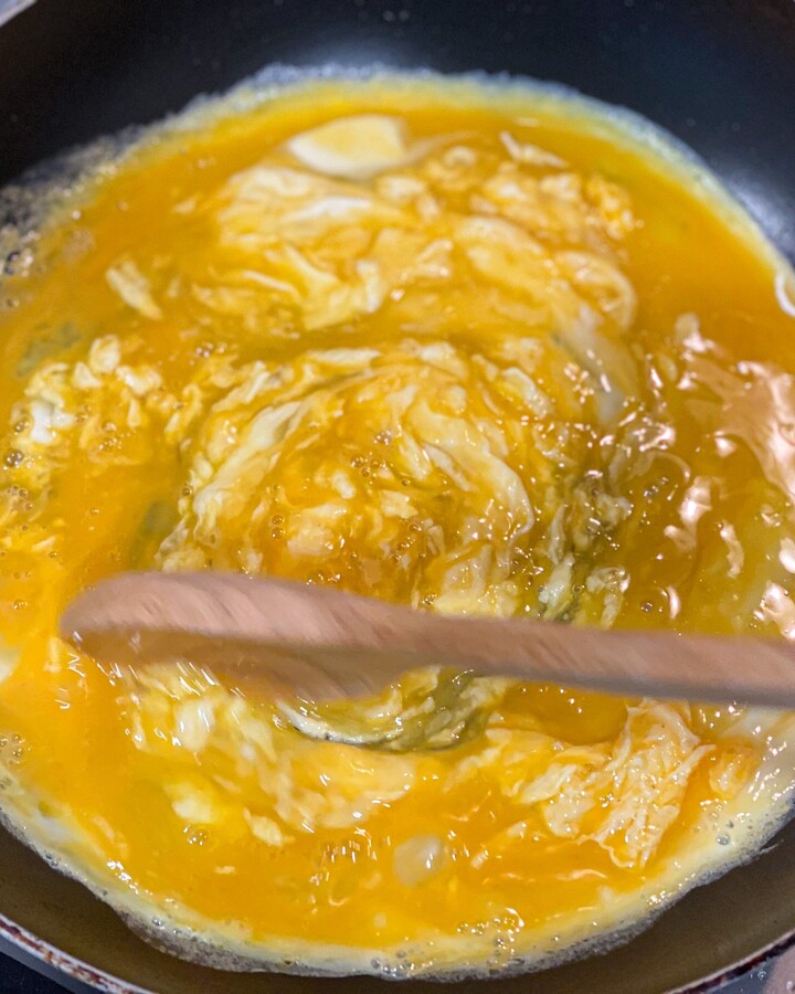 Make scrambled eggs with a non-stick pan. Melted butter in the pan. Crack the egg into the pan. Add some cheese and sprinkle some salt and pepper to add more flavor.

Tips - Use low heat when you cook scrambled eggs. It will make your eggs soft and creamy.