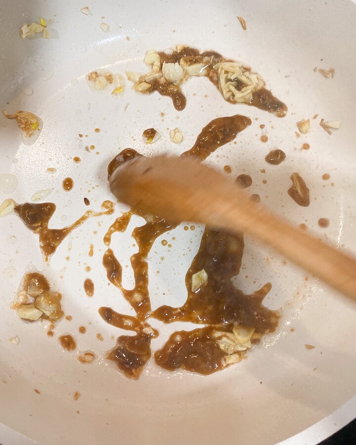 For the gravy; In a wok, heat oil over medium heat, then add the garlic and Thai fermented soy bean paste and stir it until the garlic turn golden.