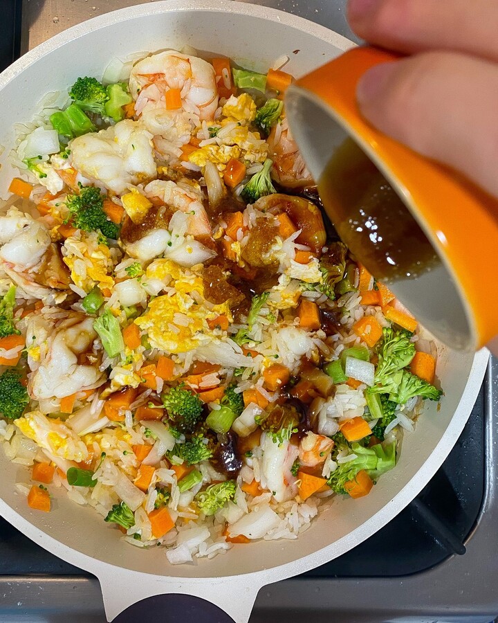 Add all mix sauce and keep stirring for 2-3 minutes until the rice is getting golden. Taste and adjust the seasoning.