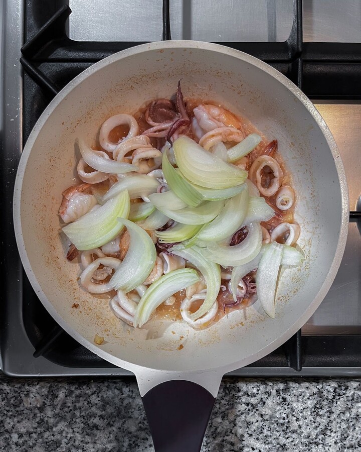 Add finely chopped onion to the pan.